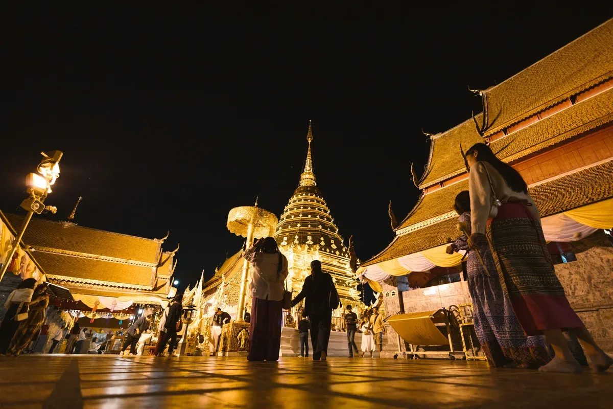 Golden temple illuminated at night in Chiang Mai